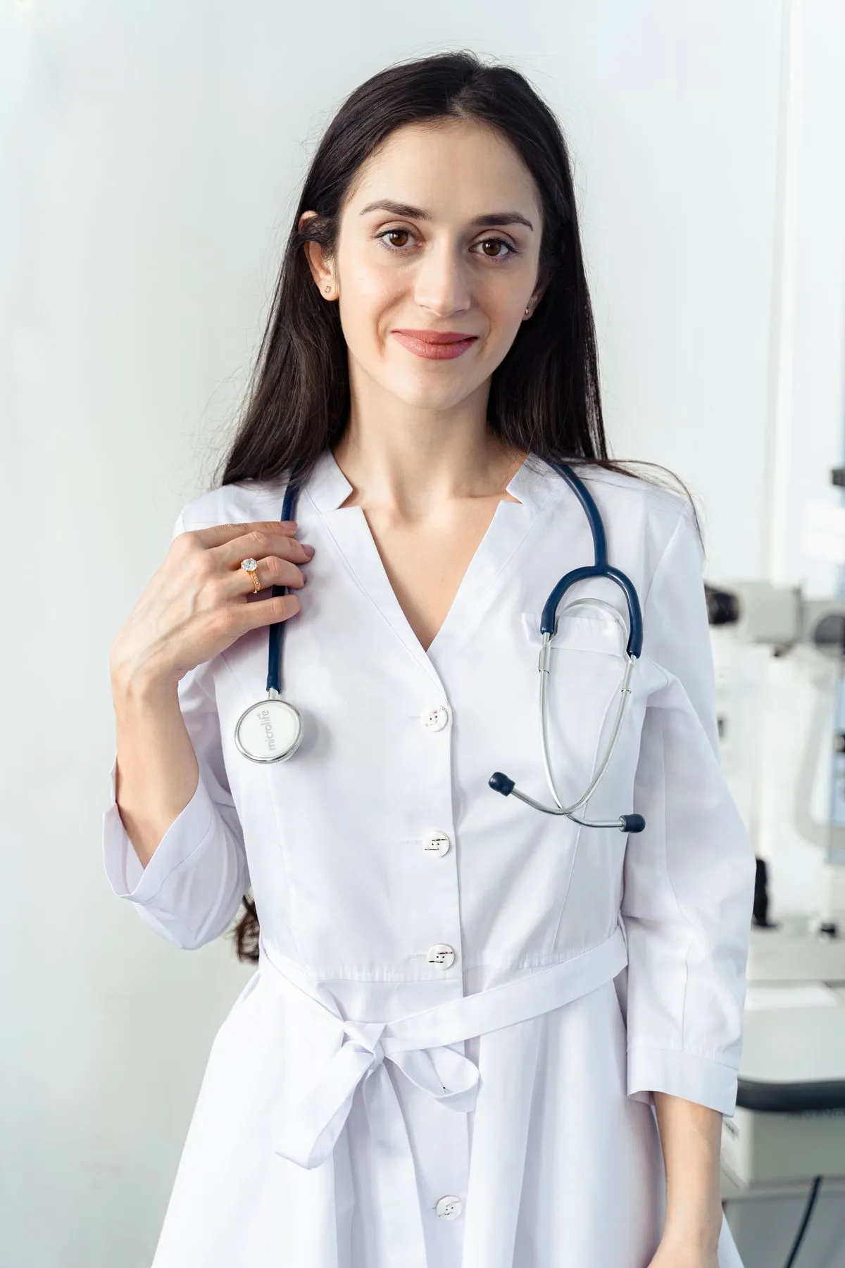Portrait of Elena, a nurse practitioner in a white coat with a stethoscope
