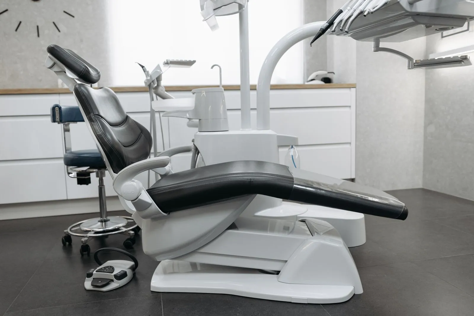 A clean, modern treatment room with a dental chair